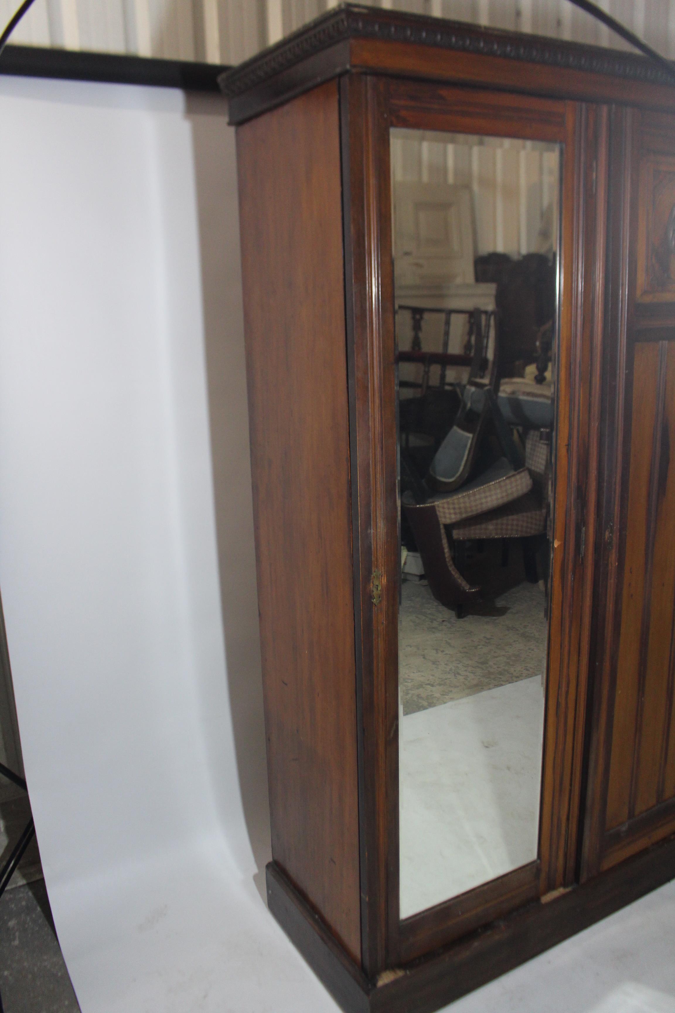 An Edwardian walnut wardrobe with moulded cornice, having fitted interior enclosed by carved panel - Image 5 of 5