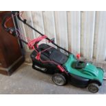 A Qualcast electric lawn mower; a folding step ladder; & various garden & hand tools.