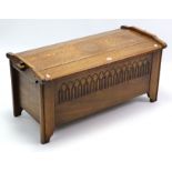 An oak blanket box with hinged lift-lid & carved front, 38½” wide.