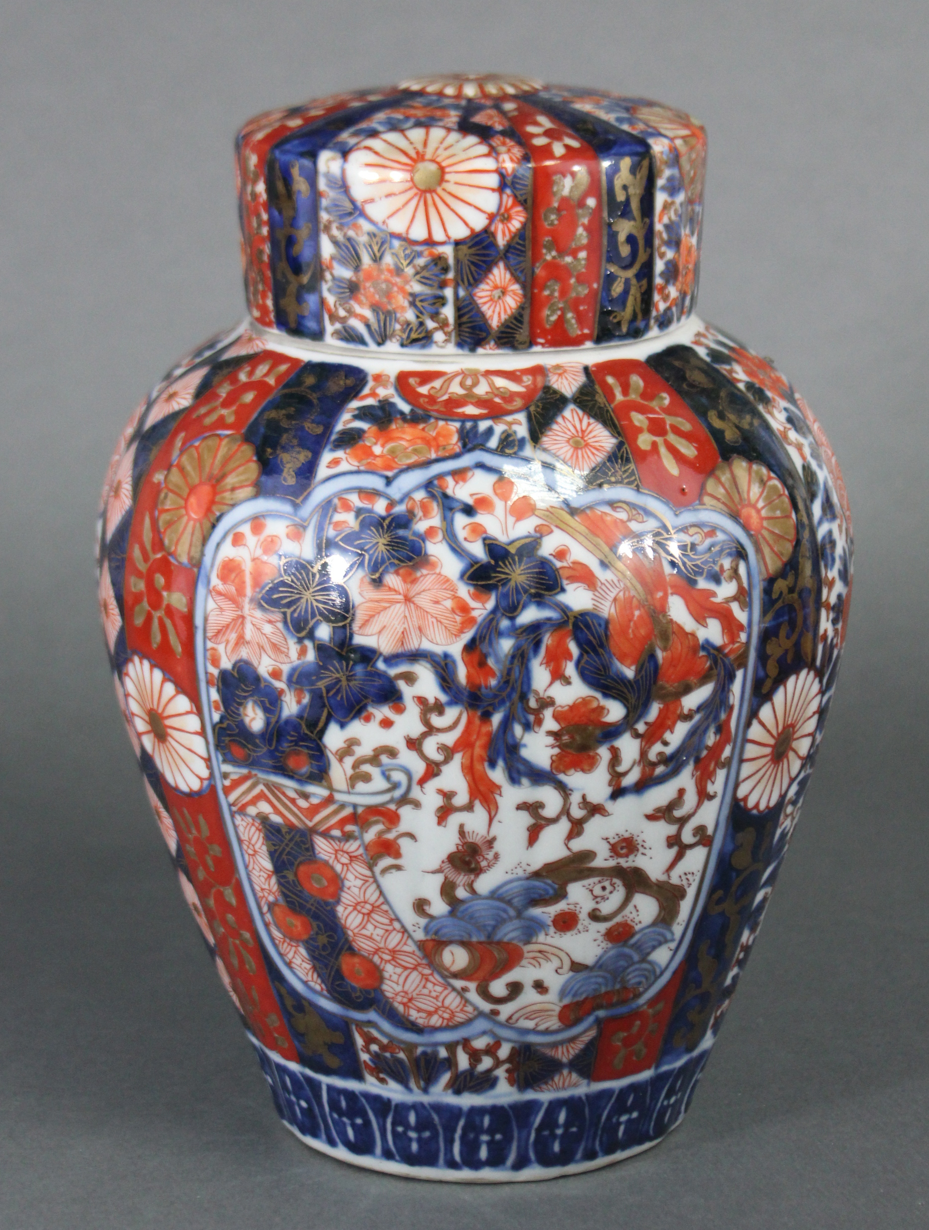 A 19th century Japanese Imari ginger jar & cover, the fluted ovoid body decorated with foliage &