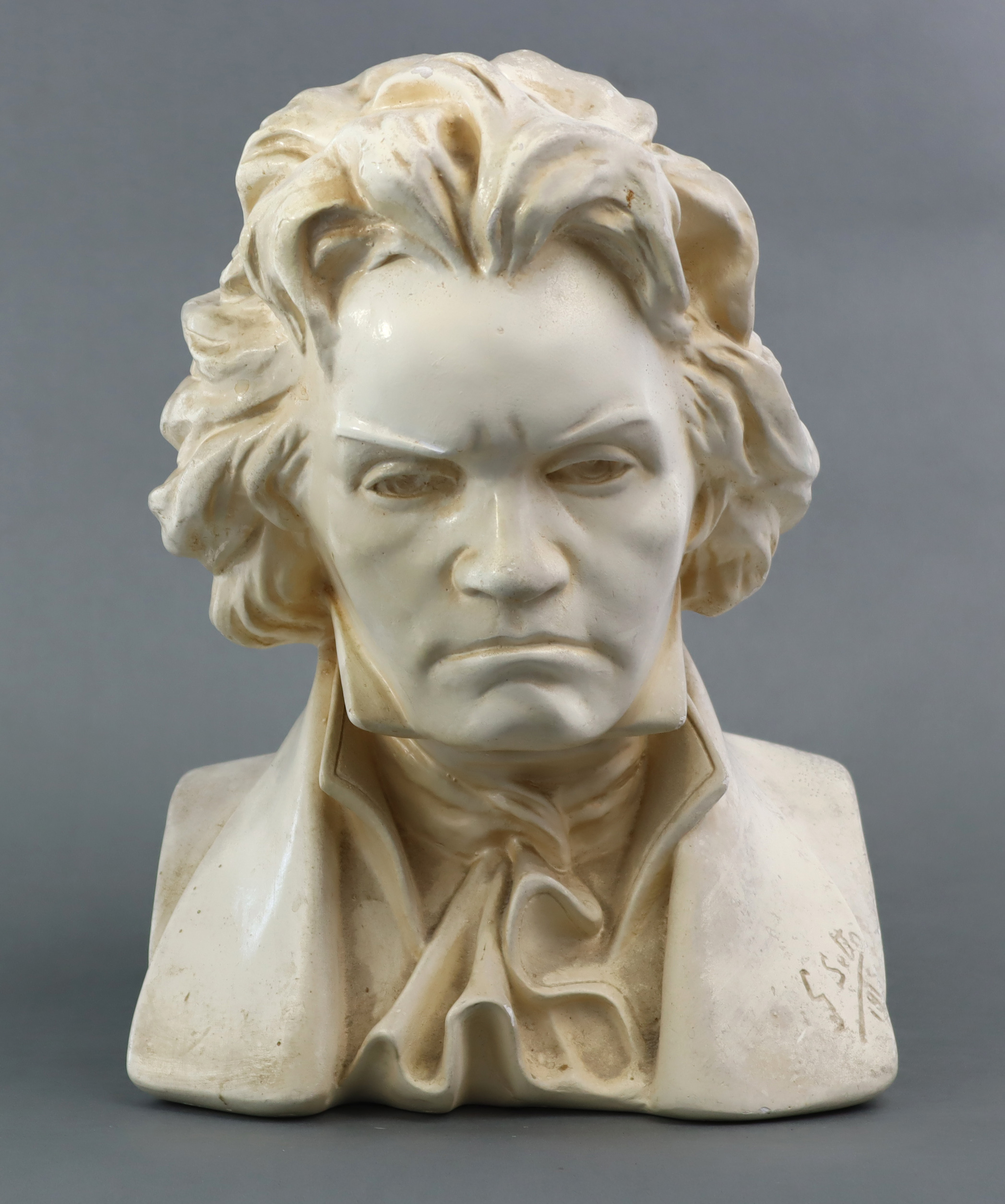 A white painted plaster bust of Beethoven, incised to base “G. Setto 1915”; 10­½” wide x 14½” high.