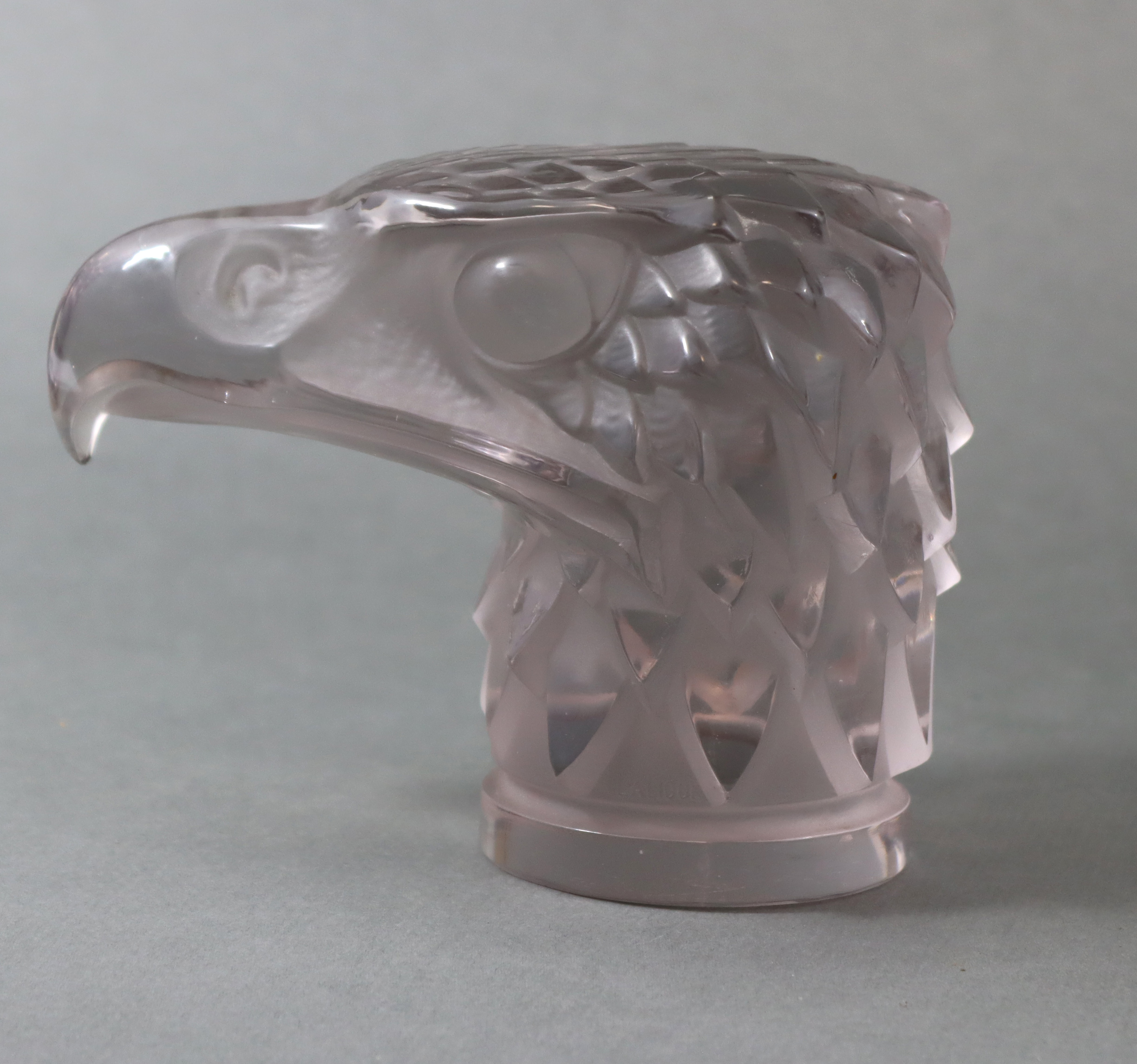 A LALIQUE CLEAR & FROSTED GLASS 'TÊTE D’AIGLE' CAR MASCOT, No. 1138, Designed 1928; 5½” wide x 4¼”