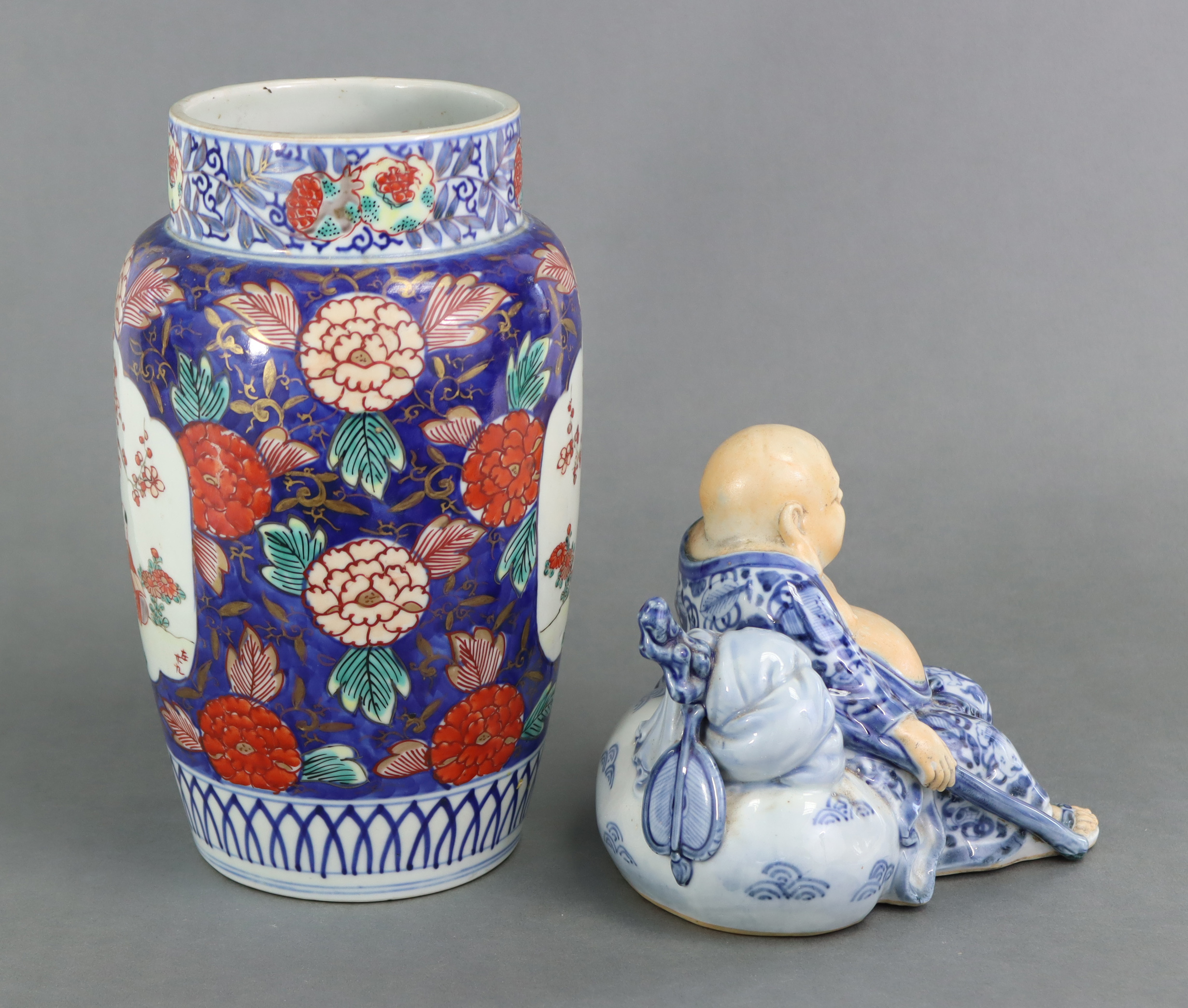 A Japanese Imari cylindrical vase, decorated with boys beside blossoming trees in reserves on a blue - Image 2 of 3