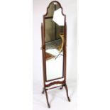 A mahogany finish rectangular cheval mirror with shaped top, on square supports & cabriole legs,