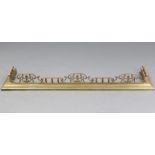 A Victorian brass fender with baluster & leaf-scroll front rail; 53½” wide.
