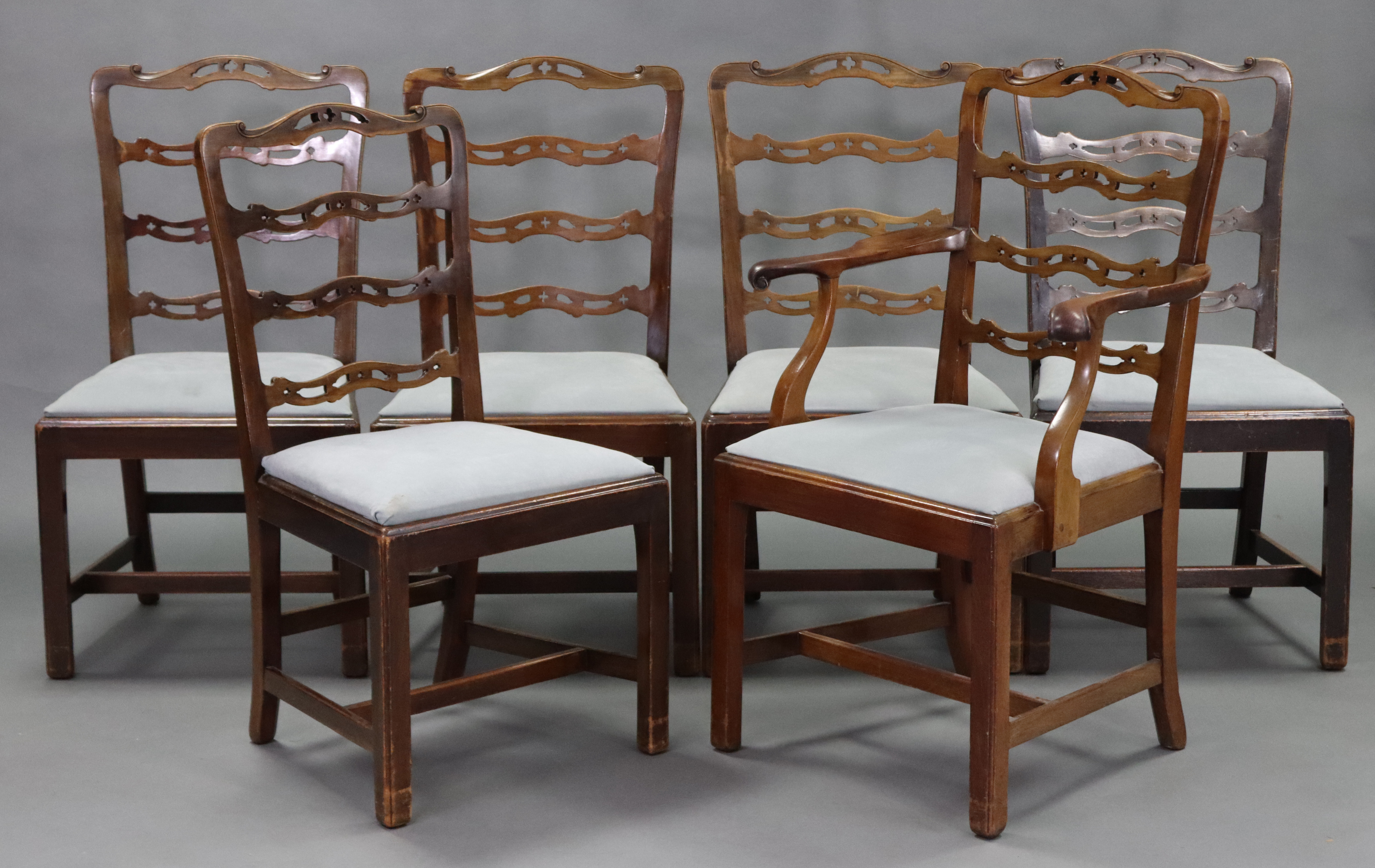 A set of six 18th century-style mahogany dining chairs, including an elbow chair, each with