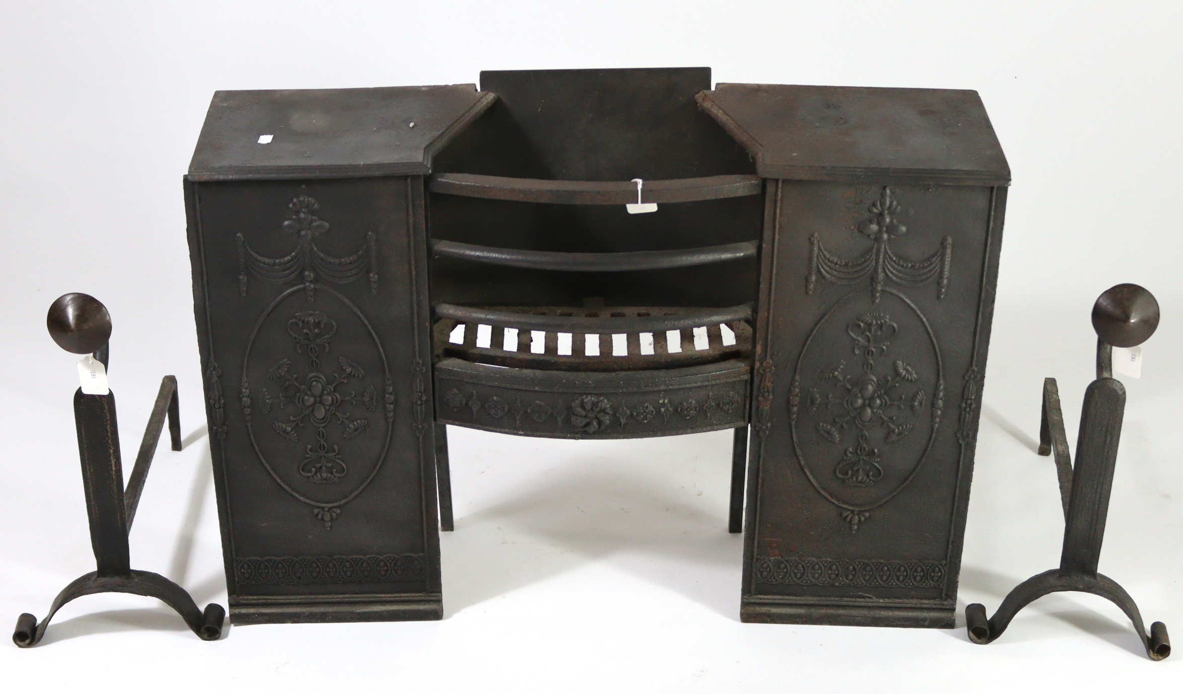 A cast-iron fire grate with Adam-style relief decoration, 35” wide x 24½” high; together with a pair