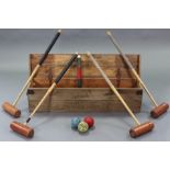 A Jaques of London croquet set comprising of four mallets, six hoops, & three balls, with deal