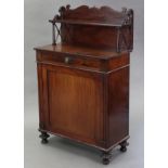 A late regency mahogany chiffonier, the stage top with shaped back & applied carved scrolls on