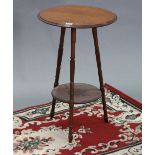 A Victorian mahogany circular two-tier occasional table on three turned & fluted legs, 15” diam.;