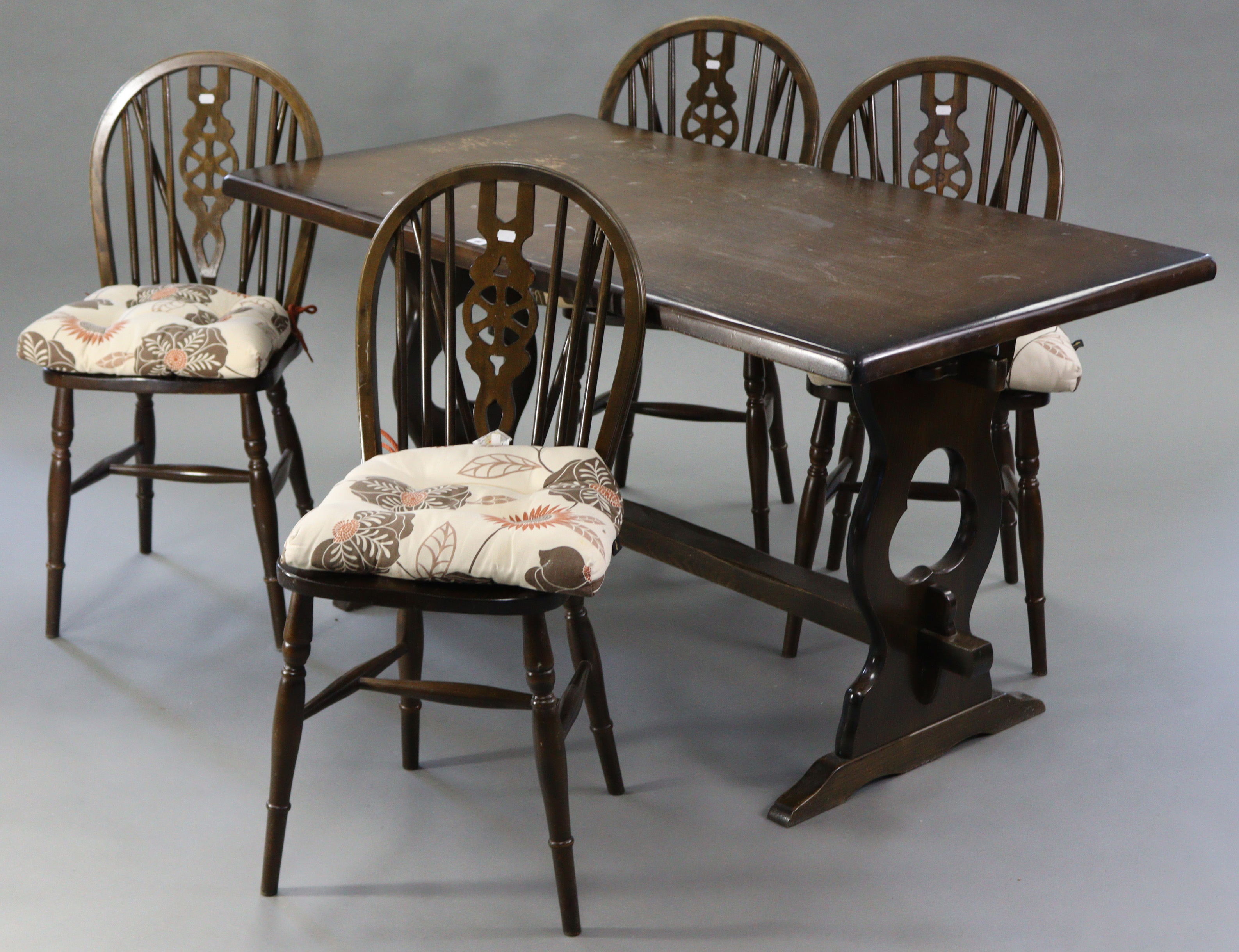 An oak refectory table with rectangular top, & on shaped end supports joined by plain centre