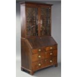 A George III figured mahogany bureau bookcase, with moulded Greek Key pattern cornice, fitted