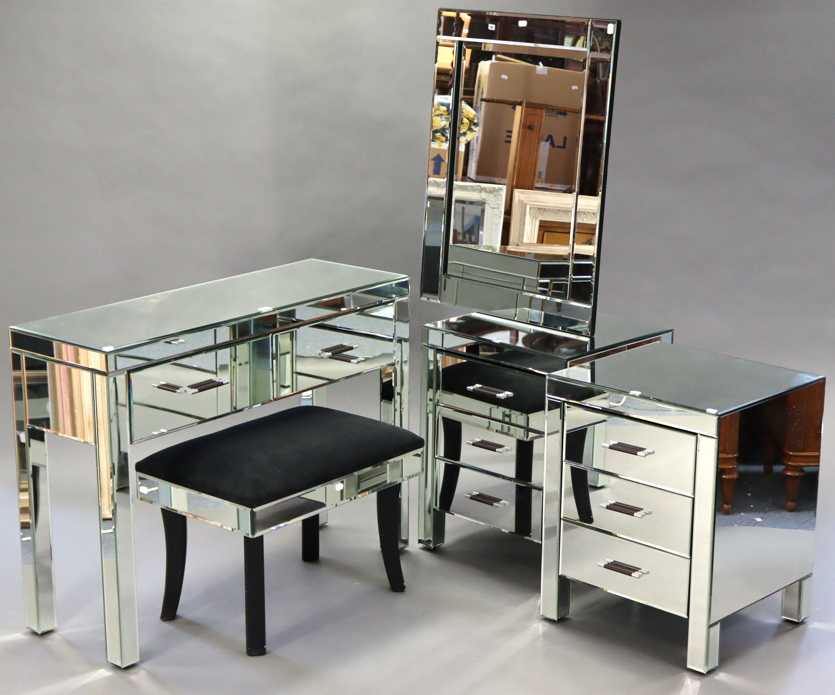 A mirrored four-piece bedroom suite comprising a two-drawer side table, 40½” wide; a pair of three-