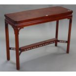 A reproduction mahogany Chippendale-style side table, with canted corners to the rectangular top, on