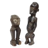 A carved wood standing figure inset cowrie-shell eyes, possibly Ugbandi or Ngbaki, 11¾” high; & a