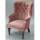 A Victorian armchair with rounded buttoned-back, scroll arms & padded seat upholstered mauve velour,
