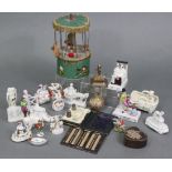 Eighteen various small china figures, groups, fairings, etc.; a clockwork Merry-Go-Round; pin cush