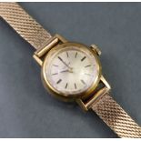 An 18K Omega ladies’ wristwatch, the circular silvered dial with gold baton numerals, with