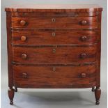 An early 19th century American figured mahogany bow-front chest, fitted four long graduated