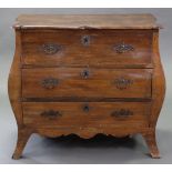 A LATE 18th century FRENCH OAK BOMBÉ COMMODE, the shaped rectangular top above three long drawers