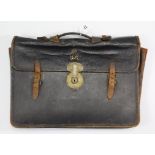 A George VI black morocco leather briefcase fitted with a brass lever lock stamped “J. Hodges & Son,