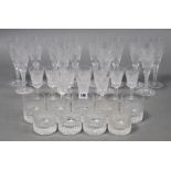 A set of twelve Stuart trumpet-shaped wine glasses, 7½” high; a set of ten Waterford glasses of