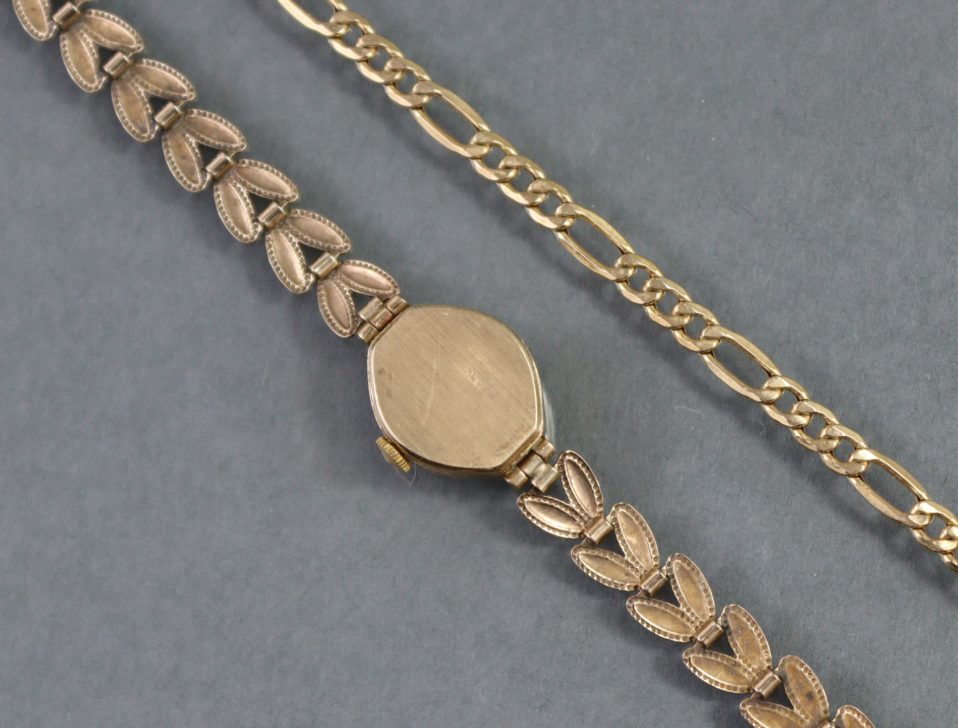 An Accurist 9ct. gold ladies’ wristwatch, the oval silvered dial with gold baton numerals & roman - Image 3 of 6