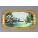 An Usher’s rectangular tin tray with pictorial views of Pulteney Bridge, Bath to the centre, 14¾”