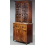 A late 18th century inlaid mahogany secretaire bookcase, the upper section fitted two adjustable