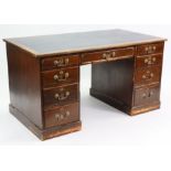 An early 20th century oak kneehole office desk, inset deep blue leatherette to the rectangular