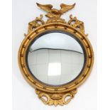 A regency-style gilt frame circular wall mirror with sphere border, & with eagle surmount, 22” diam.