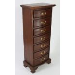 A modern mahogany finish tall narrow chest, fitted seven drawers with serpentine fronts & brass