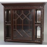 A Victorian mahogany wall cabinet with dentil cornice & blind fret-carved decoration, fitted two