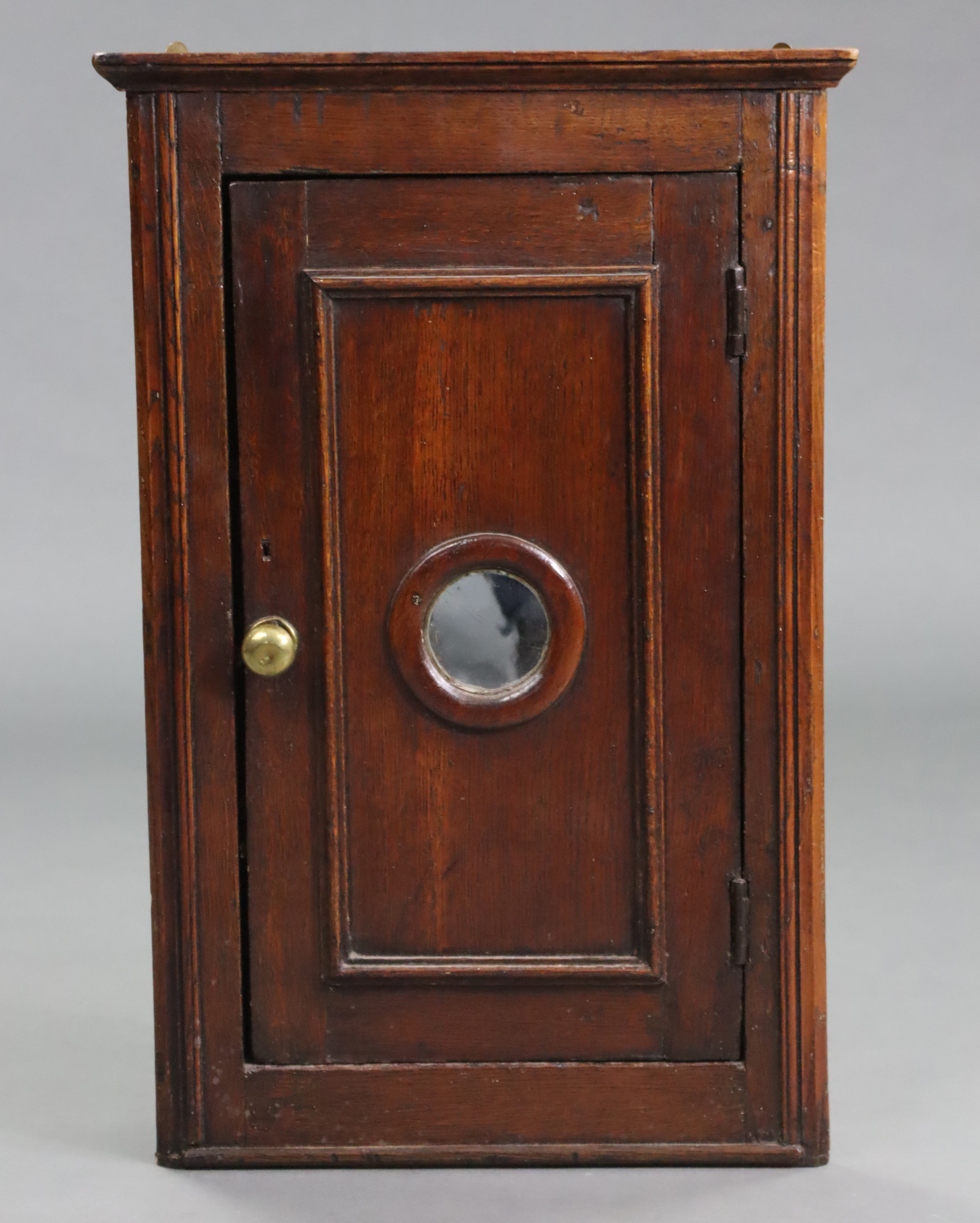 A 19th century oak small hanging corner cupboard, with moulded cornice & edges, fitted two shelves