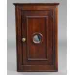 A 19th century oak small hanging corner cupboard, with moulded cornice & edges, fitted two shelves