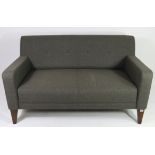 A John Lewis two-seater settee upholstered blue fabric & on square tapered legs; 55” wide.