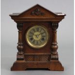 An early 20th century mantel clock with striking movement, & in walnut case, 13½” high.