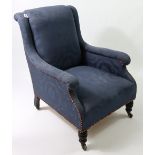 A Victorian armchair with padded seat, back & scroll arms upholstered royal blue floral damask, on