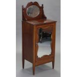 A Victorian inlaid mahogany washstand, with raised back inset oval mirror panel, above a cupboard