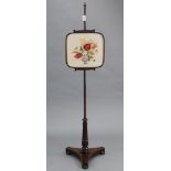 A 19th century rosewood pole banner screen with embroidered floral rise-&-fall panel, & on turned