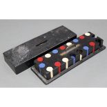 A near complete set of multi-coloured plastic gaming counters with ebonised wooden case, 19¾”