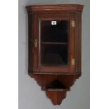 A Victorian mahogany small hanging corner cabinet fitted centre shelf enclosed by glazed door