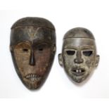 A tribal mask, possibly Zande, with cropped ridged coiffure, 11”; & another mask with two protruding