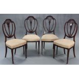 A set of four 19th century Hepplewhite-style mahogany dining chairs, with foliate carved decoration,
