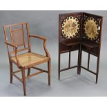 An Edwardian mahogany two-fold dwarf firescreen inset pair of embroidered floral panels above two