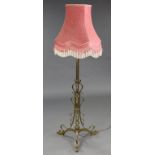An Edwardian art nouveau style all-brass standard lamp with adjustable fluted central column, ribbon