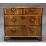 A GEORGE I FIGURED WALNUT CHEST, of diminutive proportions, the quarter-veneered crossbanded top