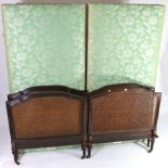 A pair of early 20th century single bedsteads with mahogany & woven cane head & foot-boards; 36”