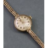 A 9ct. gold Cyma ladies’ wristwatch, the circular silvered dial with gold alternating Arabic & baton
