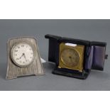 An early 20th century bedside timepiece in engine-turned sterling case with easel support, 3½” high;